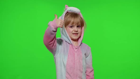 Little Child Girl Smiling Showing Thumbs Up Gesture Agree Sign in Unicorn Pajamas on Chroma Key