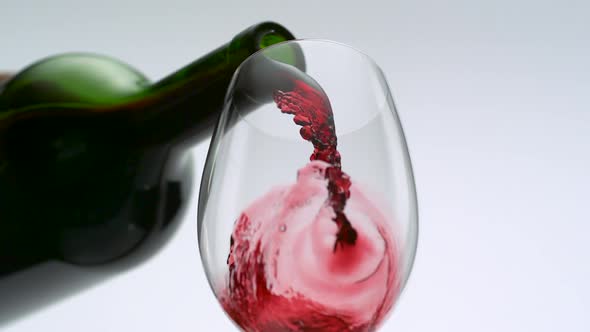 Pouring red wine into glass, Slow Motion