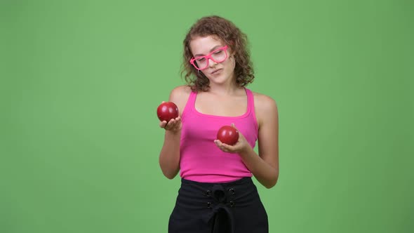 Young Beautiful Nerd Woman Showing Two Red Apples