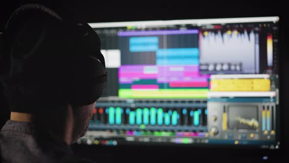 An Experienced Sound Engineer Mixes a Music Track in His Home Studio