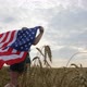Patriotic Young Woman Holds the US Flag and Runs Across the Field - VideoHive Item for Sale