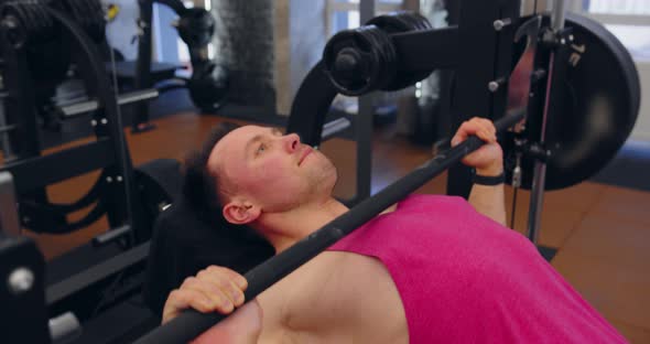 Close Up Of The Bodybuilder Does Exercise With A Barbell