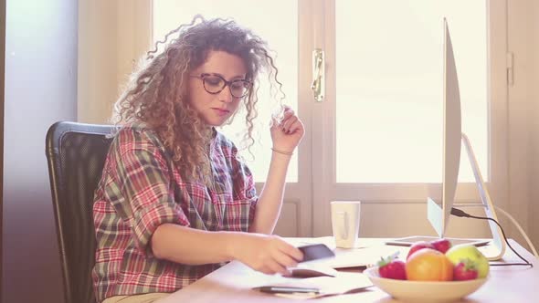 Young woman working at home or in a small office