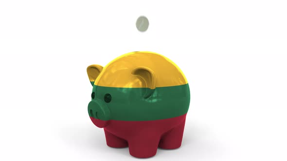 Coins Fall Into Piggy Bank Painted with Flag of Lithuania