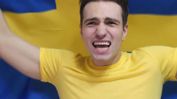 Swedish Young Man Celebrates Holding the Flag of Sweden in Slow Motion