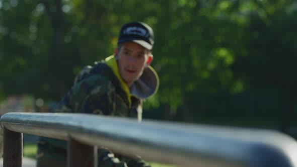 Skateboarder balancing on railing