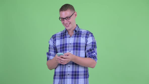 Happy Young Hipster Man Using Phone