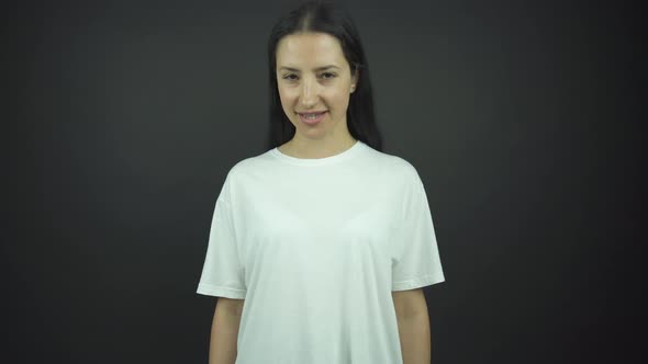 Pretty Girl in White T-shirt Demonstrates Happiness