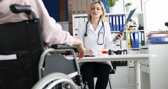 Professional Doctor Examining an Xray of Disabled Patient