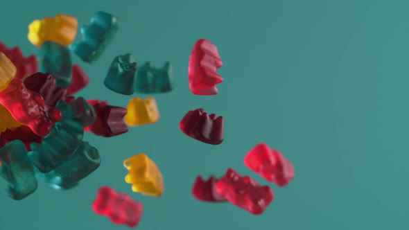 Camera follows gummy bears flying. Slow Motion. alt