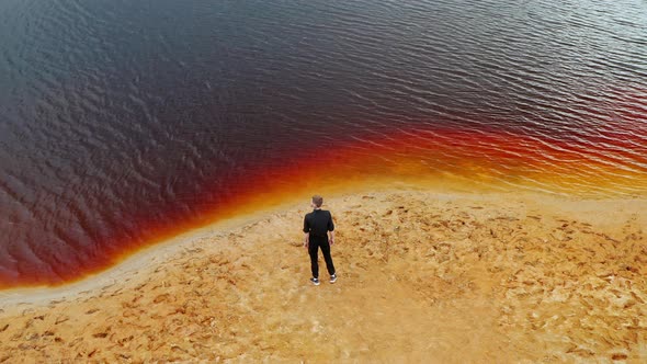 Mars planet Young man is walking in amazing red lake Ural Mars