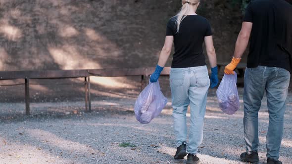 Two Volunteers Collecting Trash in the Community Park As a Weekend Activity