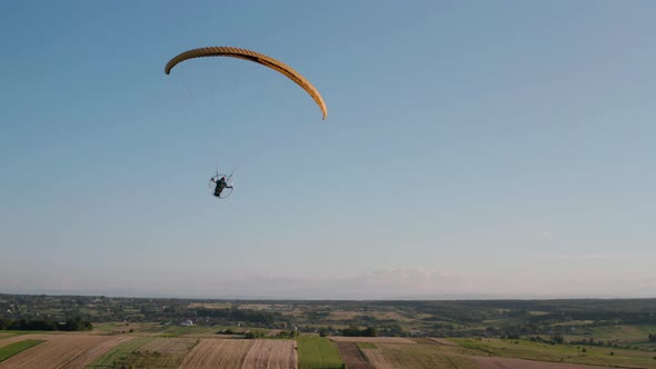 Aerial Drone View Shot of Mechanical Hang Glider Flying in Blue Sky