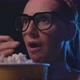 Woman watching a thriller movie and eating popcorn at the cinema - VideoHive Item for Sale