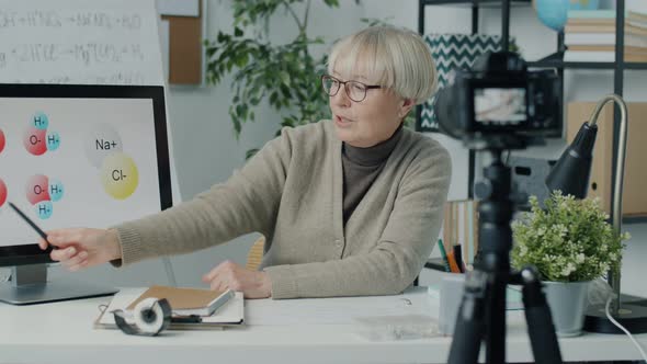 Education Vlogger Recording Video for Social Media Channel Teaching Chemistry Using Modern Camera