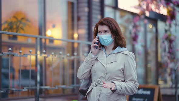 Woman in Mask Talking on Phone on the Go
