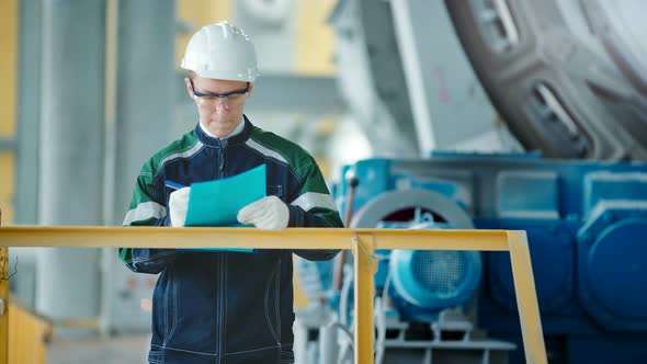 Engineer Signing a Document in Industrial Factory