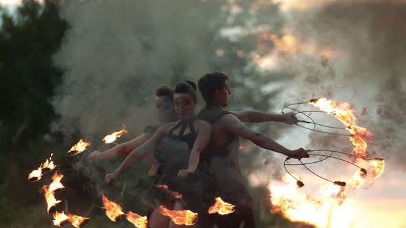 Three artists rotating with fire staffs, Ultra Slow Motion