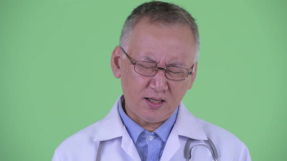 Face of Serious Mature Japanese Man Doctor Nodding Head No