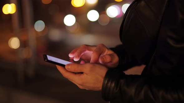 Man's Hands Are Typing a Message on the Phone