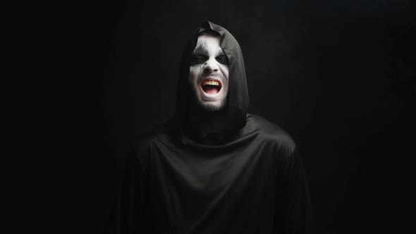 Grim Reaper with Scary Laughing Over Black Background