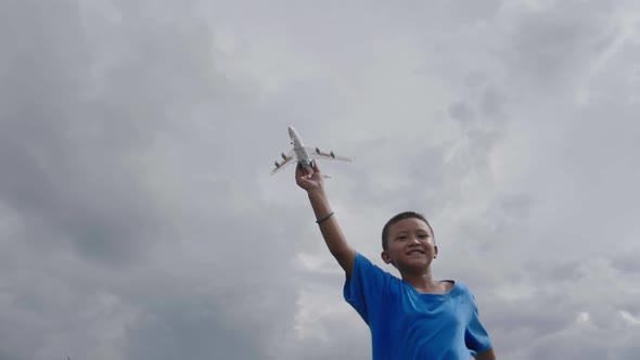 Rural Boy Running With A Airplane