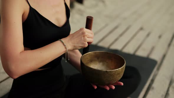 Unrecognizable Woman with Tibetan Singing Bowl for Yoga and Meditation