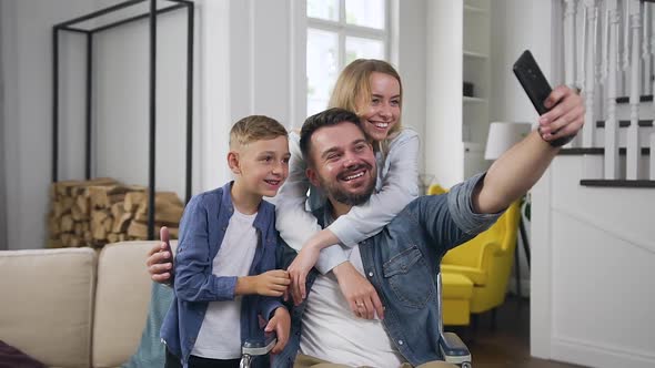 Family of 8-Aged Son, Woman and Man in Wheelchair Which Having Fun Together while Photographing