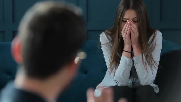 Young Woman Visiting Male Psychologist Sitting on the Comfortable Couch During Psychological Session