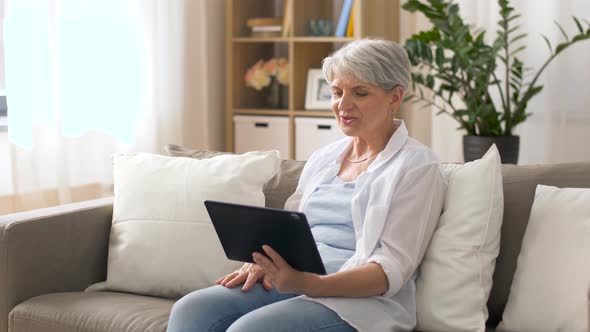 Senior Woman Having Video Chat on Tablet Pc 18