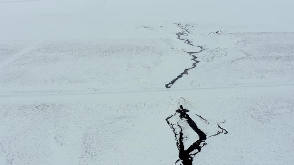 A River Running Through a Snowy Lava Field in Iceland From the Air