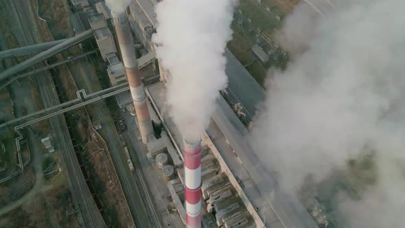 Aerial Drone View of Tall Chimney Pipes with Grey Smoke From Coal Power Plant