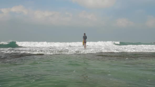 Sinhalese Man Catches Fish and Puts Into Special Bag