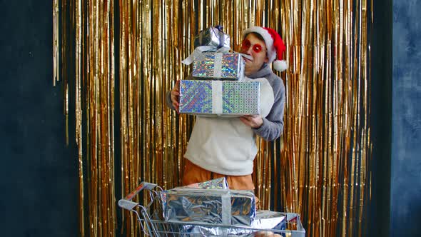 Excited Man with Cart of Gift Boxes and Baubles