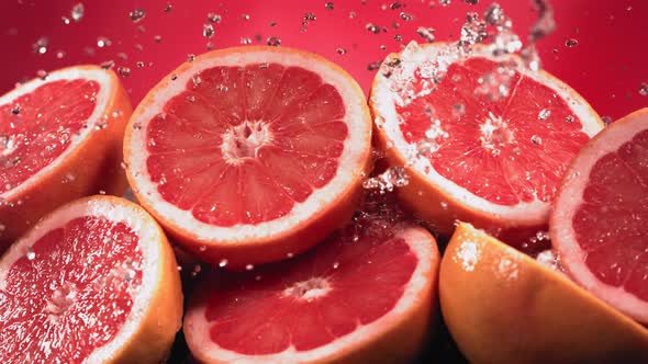 Slow Motion Shot of Grapefruit Water Splashing Through Grapefruit Slices