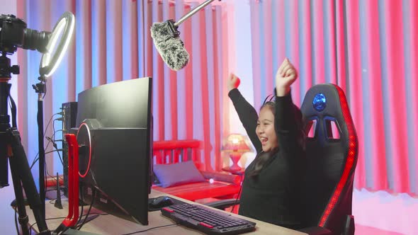 Excited Young Girl Making Winner Gesture While Playing Video Game