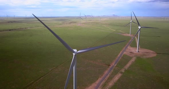 Aerial of wind turbines on the green landscape