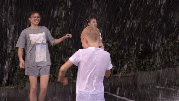 Children Play in the Fountain with a Waterfall in the Park in Summerthey Splash