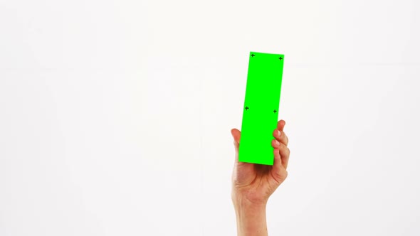 Hand of a woman holding green pla card