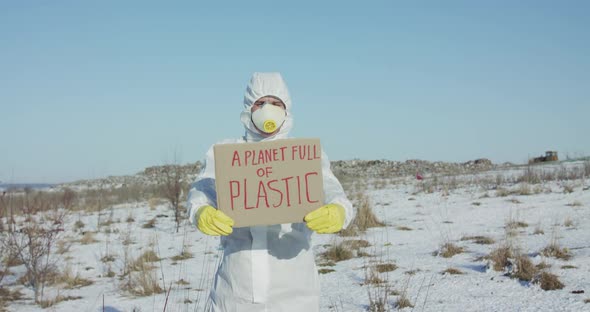 Portrait of Man Wore in Cover Suit Shows Protest Sign a Planet Full of Plastic