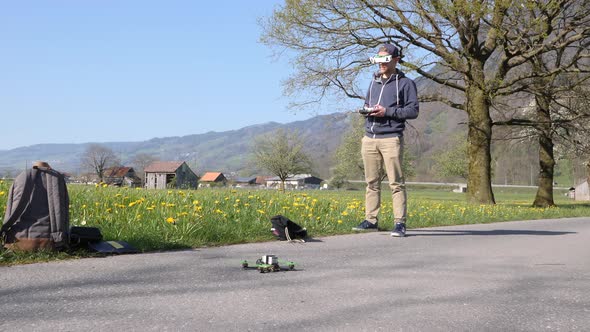 Caucasian man with vr goggles flying a fpv racing drone, slow motion wide shot