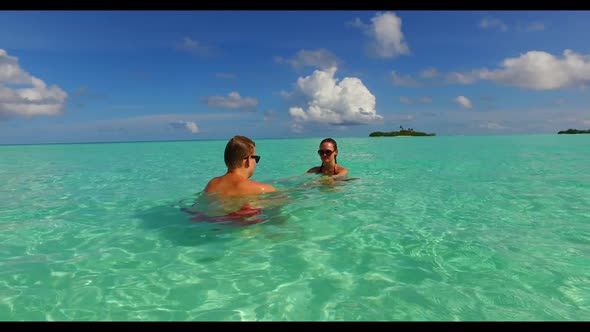 Family of two relax on paradise resort beach holiday by clear sea and clean sand background of the M