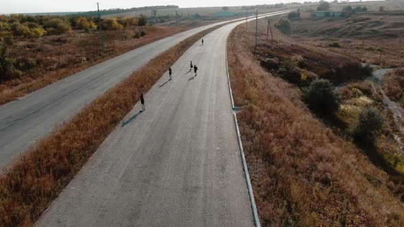 Aerial View on a Beautiful Country Road with 6 Women Longboarding