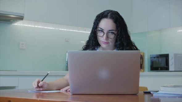 Woman Typing on Laptop Sitting on Sofa at Home, Businesswoman Sits at Home Types on Smartphone