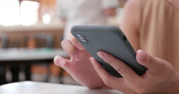 Woman use of smart phone in coffee shop