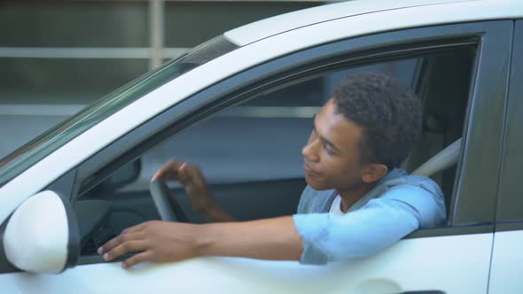 Nervous Teenager Stuck in Traffic Jam, Looking at Window Screaming to Drivers