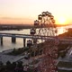 Drone View Colorful Ferris Wheel in Amusement Park on River and City Landscape - VideoHive Item for Sale