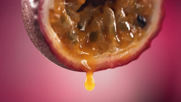 Slow Motion Macro Shot of Flowing Passion Fruit Maracuya Juice From Halved Maracuya