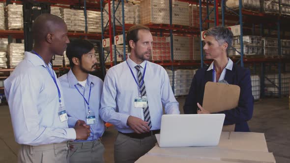 Managers and staff talking in a warehouse laoding bay 4k