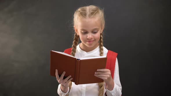 Happy Female Child Reading Book and Smiling on Camera, Education, Love to School